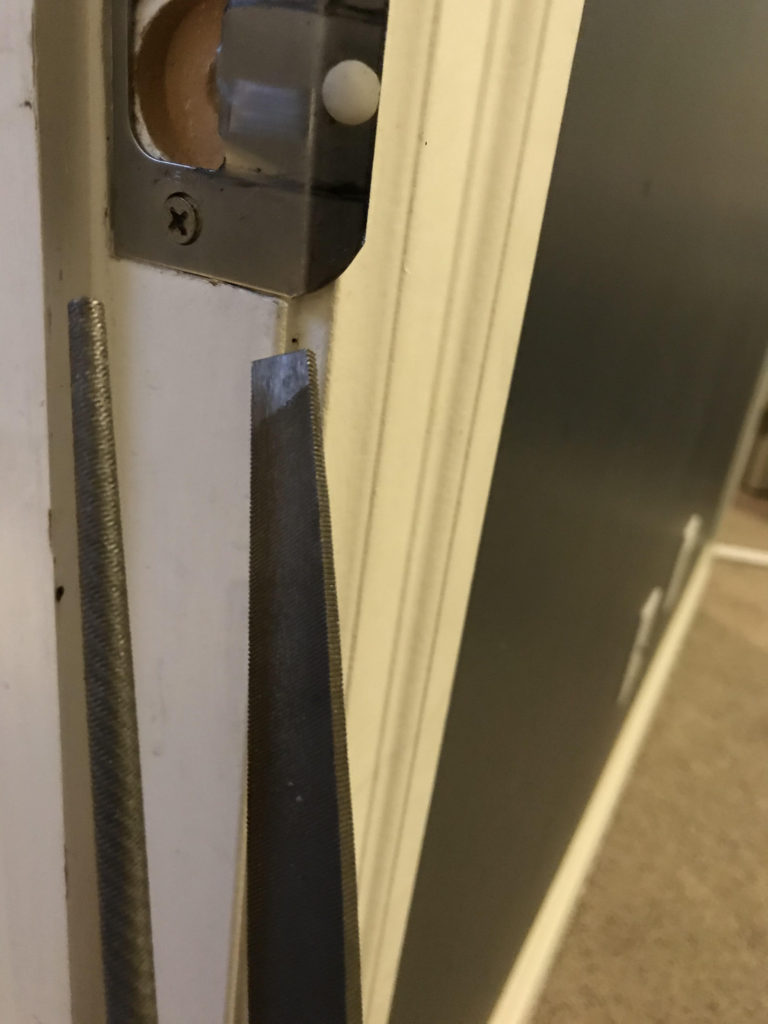 use a file to ensure the latch has enough space to fall iinto the strike hole